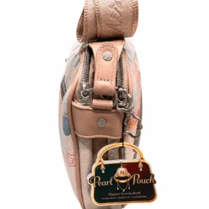 Pink printed women’s crossbody bag with adjustable shoulder strap, zip closure, cartoon artwork and spacious interior.