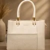 Ivory textured top handle tote bag for women with an elegant structured design, stylish patterned front panel and premium gold-tone hardware.