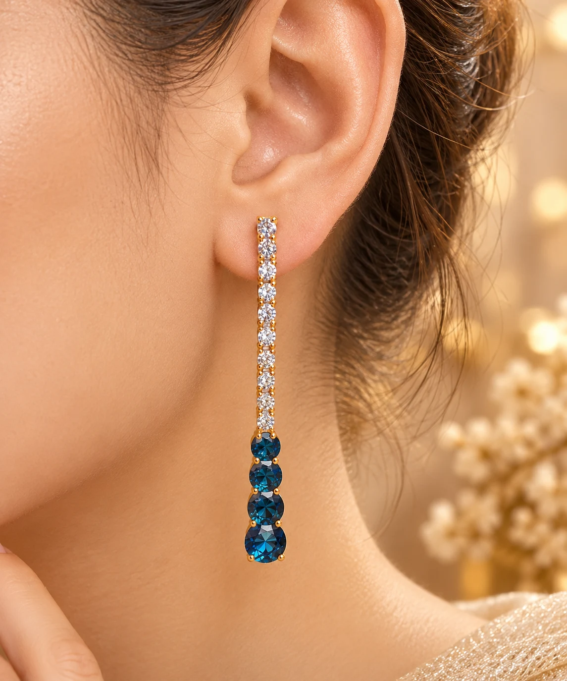 18K Royal Blue Drop Earrings (1) 18K gold plated blue stone drop earrings with sparkling clear stones and an elegant elongated design