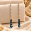 18K gold plated blue stone drop earrings with sparkling clear stones and an elegant elongated design