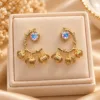 Gold plated floral drop earrings with iridescent stone and textured floral charms