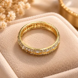 Dazzling gold tone crystal ring with wavy band and clear sparkling stones