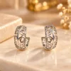 Elegant Silver Plated Scroll Earrings with intricate openwork design and curved detailing