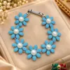 Elegant XUPING Silver Plated Floral Bracelet with blue flowers, pearl centres and silver-plated detailing