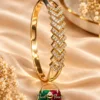 ZUPING 18K Gold Plated Zirconia Bracelet displayed flat showing the sparkling geometric centre