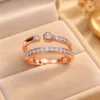 Exquisite rose tone open ring with sparkling clear stones and polished finish