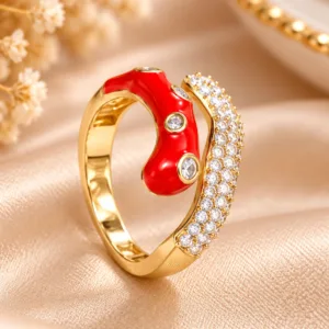 Red enamel gold tone ring with sparkling clear stones