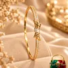 Premium 18K Gold Plated Zirconia Bracelet by Zuping with sparkling zirconia stones and an elegant central bow-inspired design