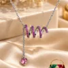 Elegant Silver-Plated Pink Zirconia Necklace by ZUPING featuring a pink wave motif and dangling heart-shaped pendant