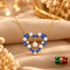 18K Gold Plated Blue Zirconia Heart Pendant Necklace by Zuping with white pearl-like decorative elements and a dangling centre ornament.