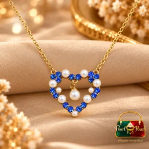 18K Gold Plated Blue Zirconia Heart Pendant Necklace by Zuping with white pearl-like decorative elements and a dangling centre ornament.